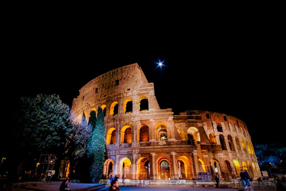 colosseum illuminated night view with people