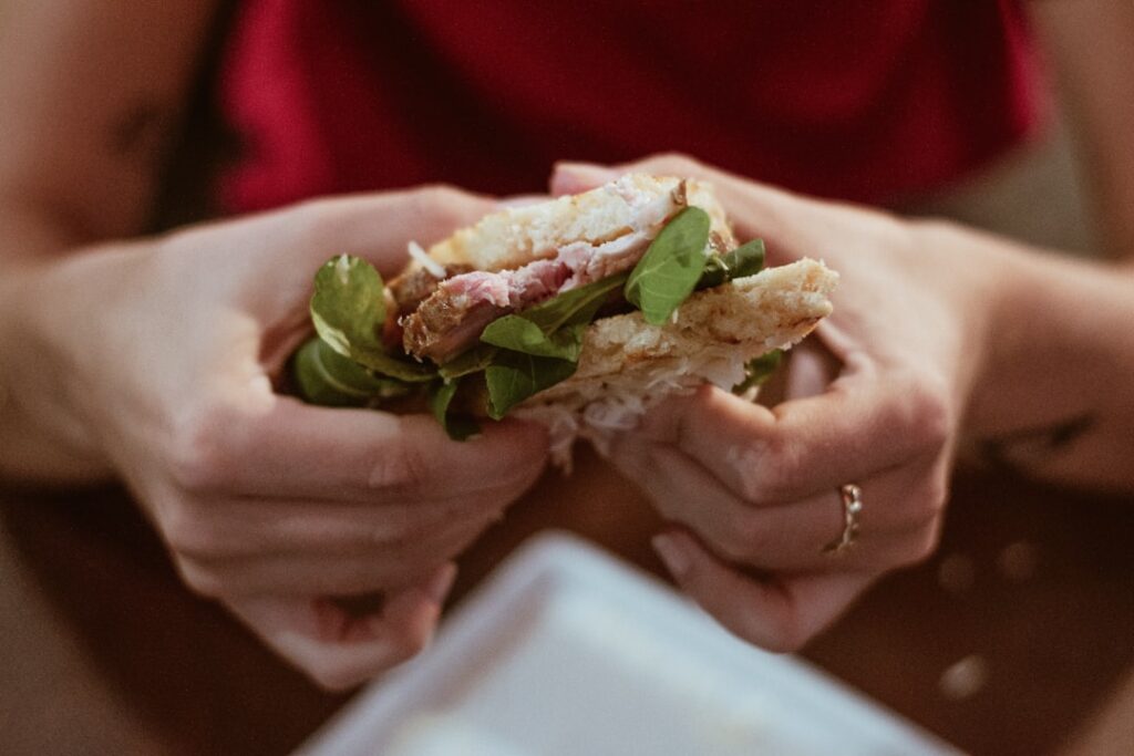 hands holding testaccio trapizzino sandwich close up