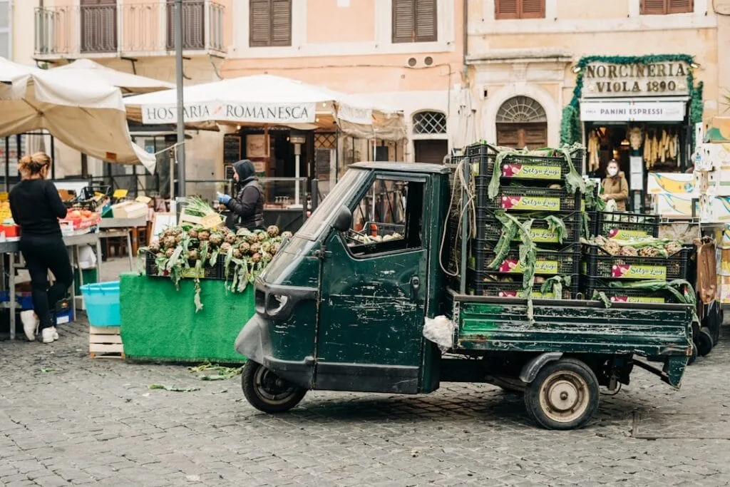 Petit camion Piaggio chargé de cagettes et d'artichauts au marché de Rome